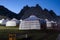 Yurt camp at night, rocky mountains in the background. Ger campsite in rural Mongolia