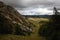 Yurt camp surrounded by trees on the ridge of the mountain. Small ger huts on the crest of the hill on a sunny day