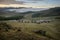 Yurt camp surrounded by trees on the ridge of the mountain. Small ger huts on the crest of the hill on a sunny day