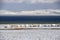 Yurt town on the shore of Son-Kul lake on the background of snow-capped mountains. Travel. Kyrgyzstan