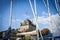 Yvoire, France - September 2016: Sailing boats moored with their sails furled in a pretty lakeside harbour on Lake Geneva.