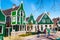 Zaanse Schans village, Holland, green houses against blue cloudy sky