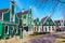 Zaanse Schans village, Holland, green houses against blue cloudy sky