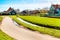 Zaanse Schans village, Holland, green houses against blue cloudy sky