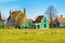 Zaanse Schans village, Holland, green houses against blue sky