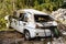 Zabljak, Montenegro - 23 july 2020: Flood damaged car. A dented white passenger car, broken windows, branches and