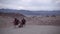 Zabriskie Point in Death Valley, California. Two Girls Are Chilling and Watching Sunset III