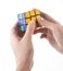 ZAGREB, CROATIA - MARCH 13, 2015: Hands solving Rubiks Cube. Rubiks Cube is invented by Erno Rubik in 1974. He is a Hungarian in