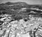 Zahara de la Sierra, Andalusia. Aerial view of whitewashed houses sporting rust-tiled roofs and wrought-iron window bars