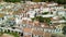 Zahara de la Sierra, Andalusia. Aerial view of whitewashed houses sporting rust-tiled roofs and wrought-iron window bars