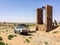 Zaida, Morocco - April 10, 2015. Old vintage silver off road car with travelers by stone water well in desert