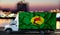 Zaire flag on the side of a white van against the backdrop of a blurred city and river. Logistics concept