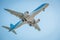 Zakynthos, Greece, August 2019: Big airplane, probably TUI, with landing gear down, under belly view, during landing at