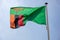 Zambia flag waving against clear blue sky