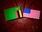 Zambian flag with USA flag on a tree stump