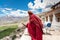 ZANSKAR, INDIA - JULY 15, 2015 : Untitled lama waiting for mystical mask dancing at Karsha Monastery (one of the oldest monastery