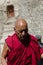 ZANSKAR, INDIA - JULY 15, 2015 : Untitled lama waiting for mystical mask dancing at Karsha Monastery (one of the oldest monastery