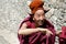 ZANSKAR, INDIA - JULY 15, 2015 : Untitled lama waiting for mystical mask dancing at Karsha Monastery (one of the oldest monastery