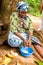 Zanzibar, Coconut processing,woman scrapes the coconut from the nut
