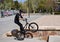 Zaragoza , Spain; 03 23 2019 : sport man wearing helmet, t-shirt, gloves and trousers in black riding a bmx bicycle getting up the