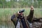 Zasavica, Serbia - April, 19th 2014.: Man with binoculars bird watching pointing finger up