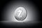 Zcash cryptocurrency physical concept coin on gently lit dark background.