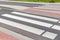 Zebra cross walk on asphalt road. The crosswalk is in the city