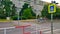 Zebra crossing with highly reflective road sign with old style block of flats on the other side of the road