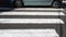 Zebra pedestrian marking with car,close-up, passing car on zebra crossing.