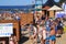 ZELENOGRADSK, KALININGRAD REGION, RUSSIA - JULY 29, 2017: Unknown people standing in queue to dressing-room on a sandy beach.