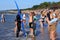 ZELENOGRADSK, KALININGRAD REGION, RUSSIA - JULY 29, 2017: Unknown surfers with surfboard standing on a sandy beach.