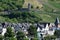 Zell an der Mosel, Germany - 07 19 2022: Old town houses with vineyards and Runder Turm above