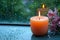 Zen ambiance aroma candle near window with raindrops in monsoon