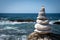 Zen balanced stones stack - ocean and waves in background