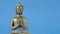 Zen.Buddha statue on a blue background.Meditation and relaxation symbol.Buddhism religion background.Calm, balance and