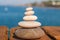 Zen concept. Pyramid of stones on the seashore. Blurred background. Concept of harmony, stability, life balance, and