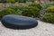 Zen garden dry landscape, or karesansui, japanese rock garden with black stones on white gravel for relaxation and