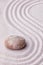 Zen garden with a marble rock and wave pattern in sand