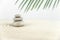 Zen garden. Pyramids of white and gray zen stones on the white sand with abstract wave drawings.