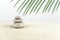 Zen garden. Pyramids of white and gray zen stones on the white sand with abstract wave drawings.