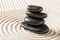 Zen garden with stacked black pebbles