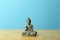 Zen, meditation and relaxation background. Buddha figurine on an empty calm blue background