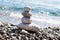 Zen sea stones pebbles stacked in a pyramid on sea coast