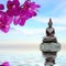 Zen stone,orchid flowers and Buddha reflected in water