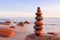 Zen stones on a background of pink sky and sea. The concept of peace and harmony