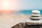 Zen stones are background. A pyramid of pebble stones against the background of the sky, sea and beach. Meditation, yoga