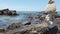 Zen stones balance at stony beach and sea background