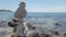 Zen stones balance at stony beach and sea background