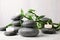 Zen stones, bamboo and lighted candles on table