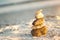 Zen Stones on beach for perfect meditation. Calm zen meditate background with rock pyramid on sand beach symbolizing stability, ha